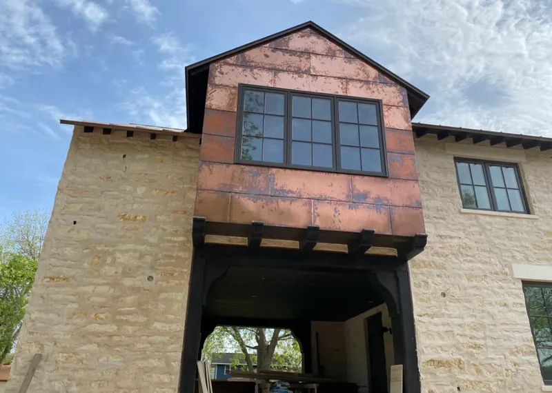 Copper metal panel facade on a stone building for Roof Repair in Alamosa